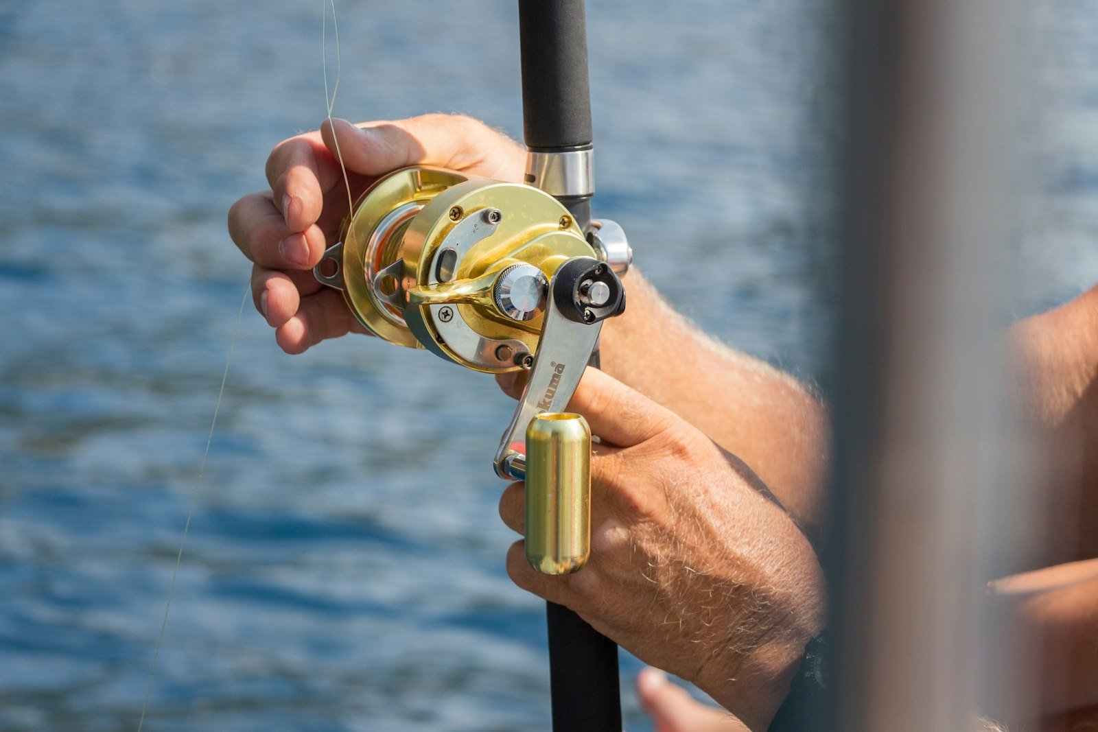 Angler holding a fishing reel on a charter boat